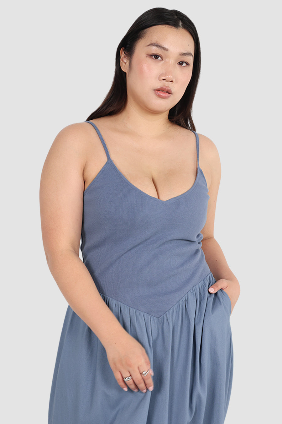 Woman wearing a blue dress against a white background